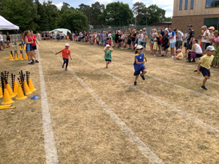 Children running along track sports day