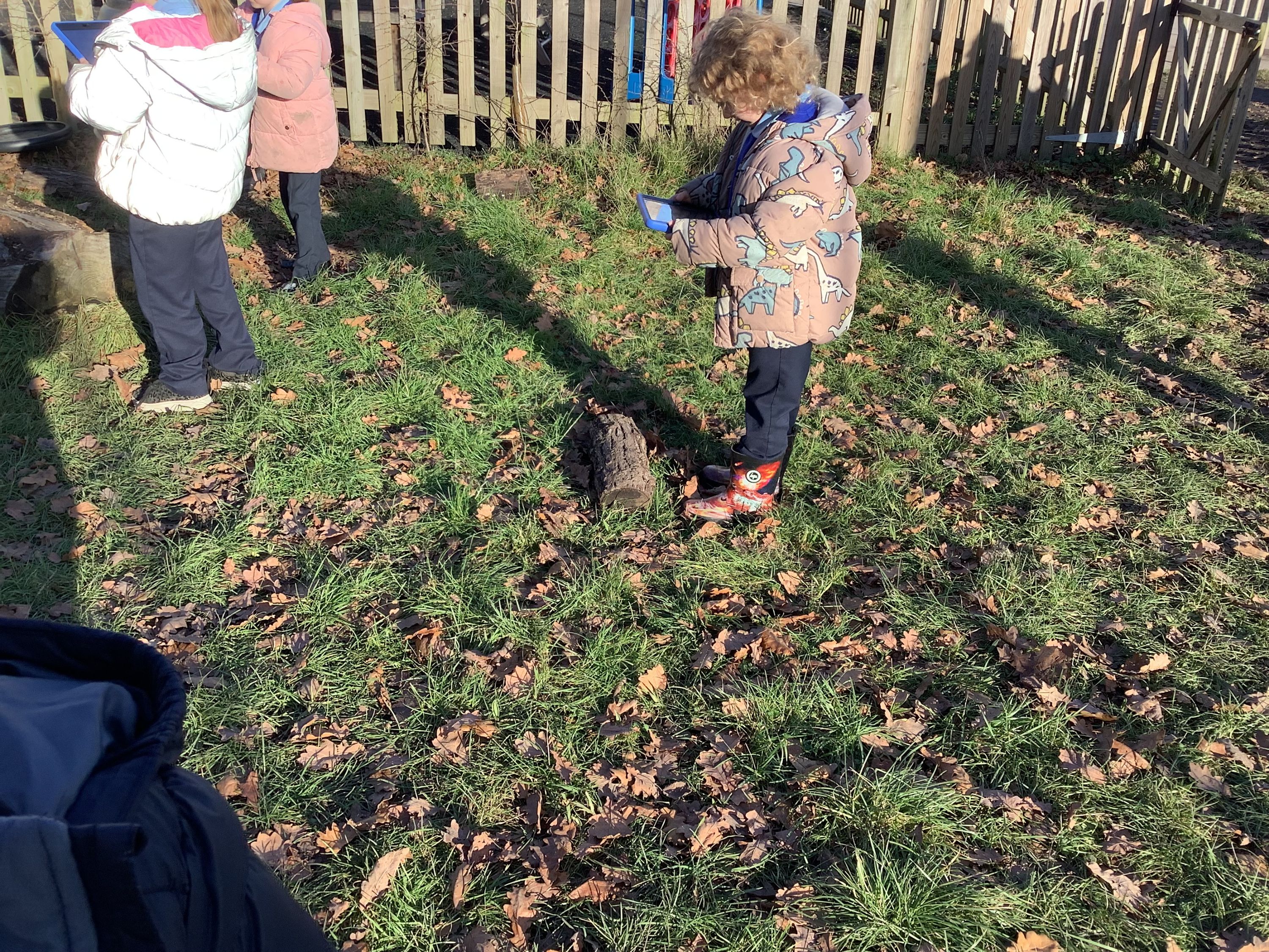 image of children using technology outdoors
