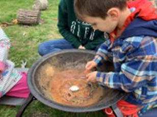 image of child lighting fire pit
