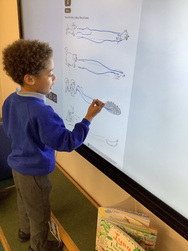 image of child using interactive whiteboard