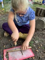 image of child cutting sticks