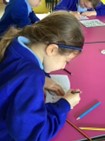 Image of pupil writing out spellings in a book