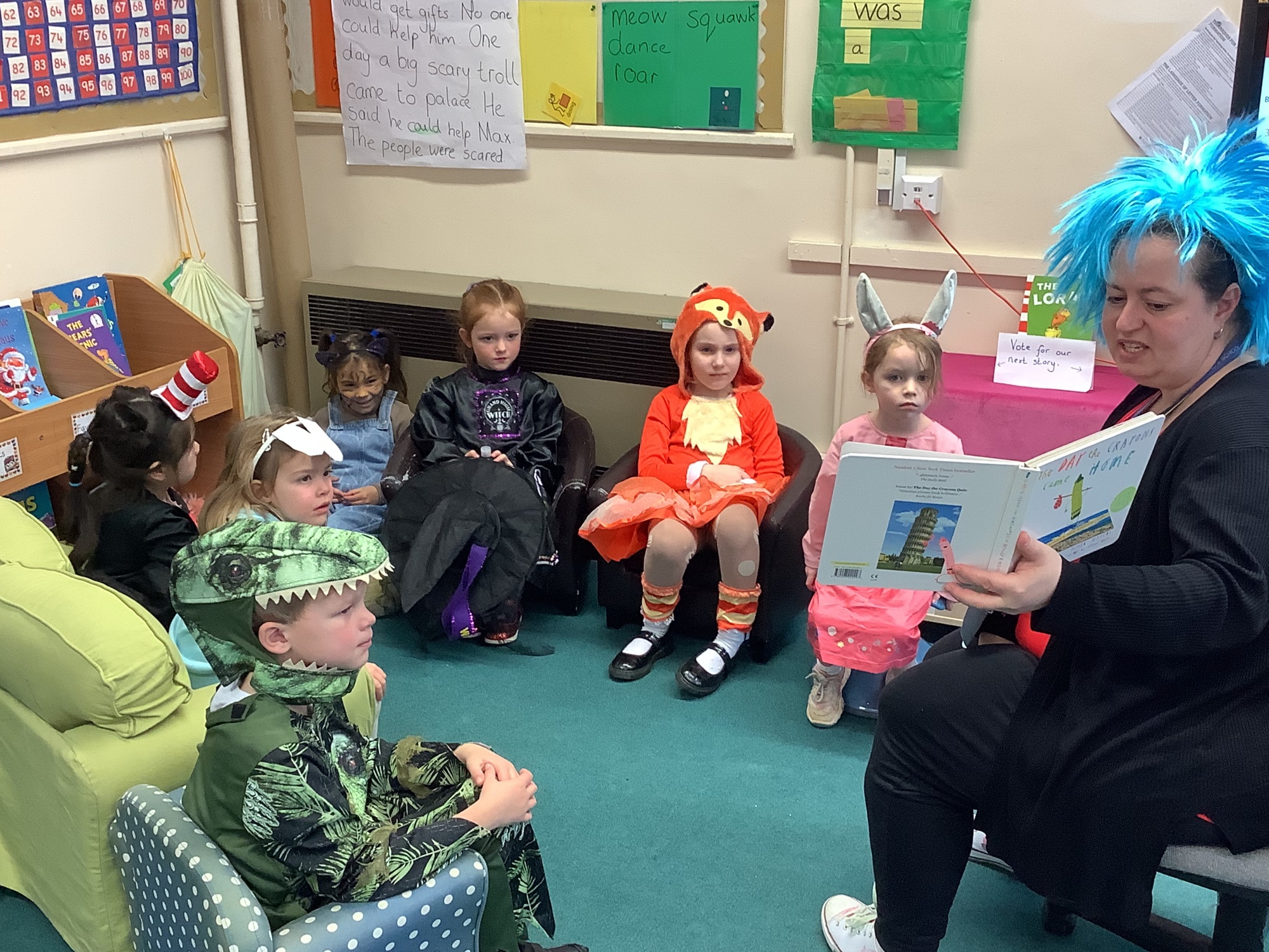 Reading to a group of children all in costume for World Book Day 24