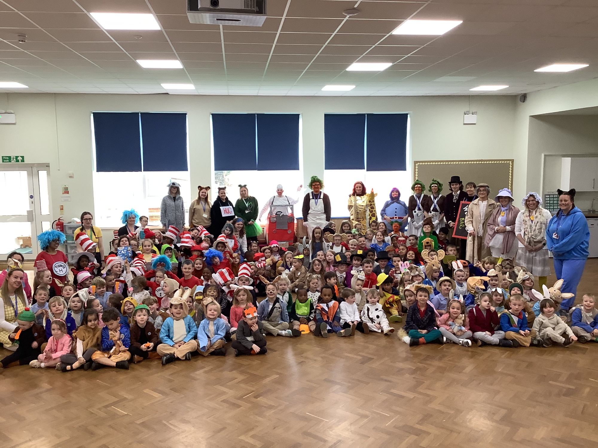 Image of World Book Day, whole school dressing up and posing in hall