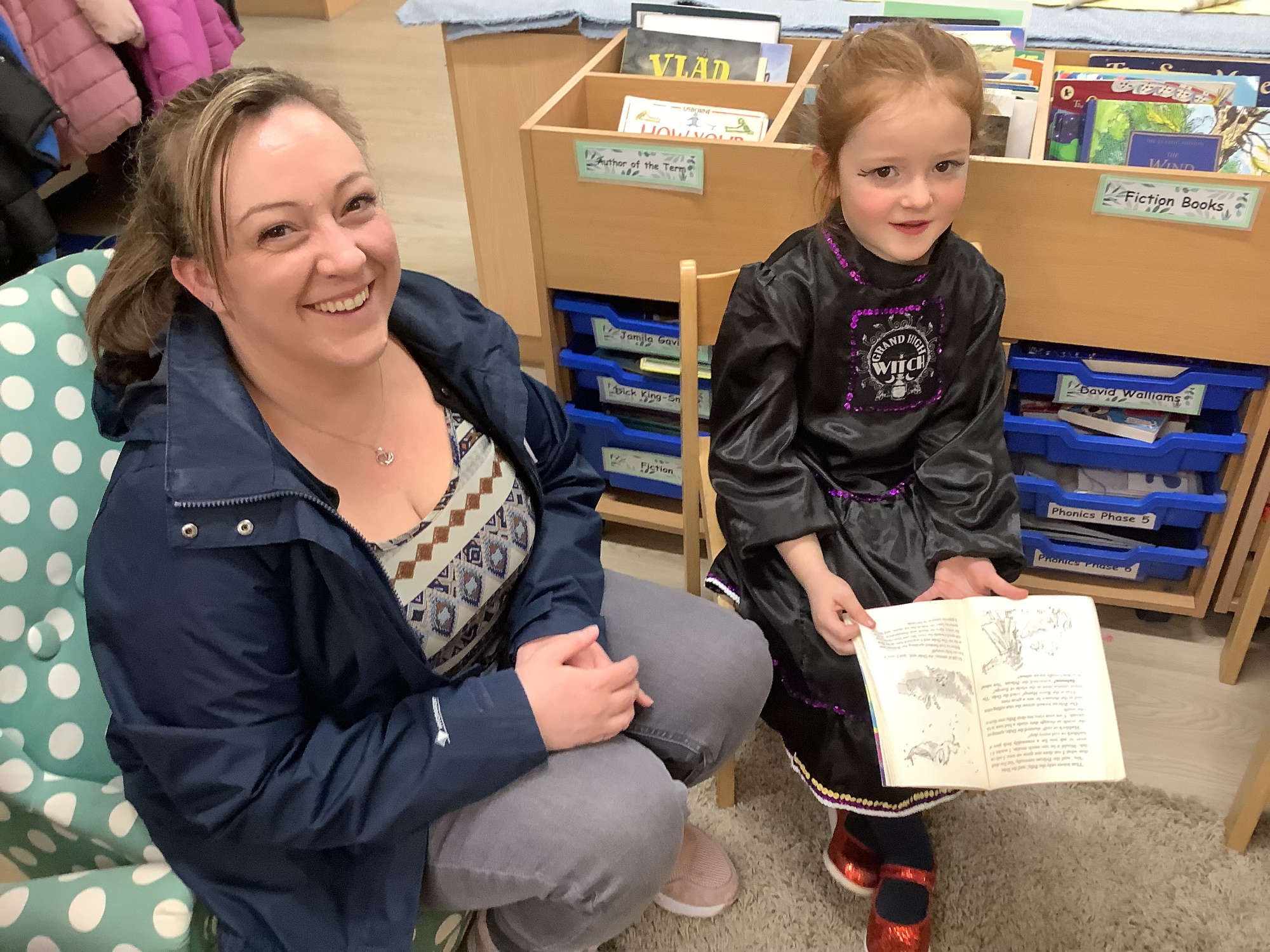 Parent reading with child dressed up in costumes for World Book Day 24